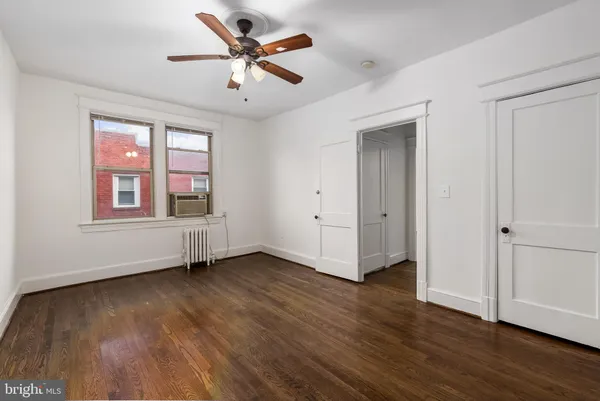 a bathroom with a shower sink mirror and toilet