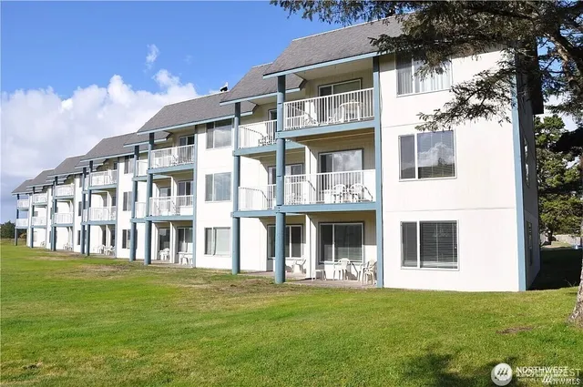 a front view of a building with a garden