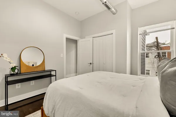 a bedroom with a bed and a dresser