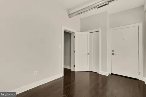 a view of an empty room with wooden floor