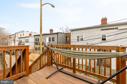 a view of a balcony with wooden floor and fence