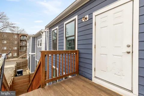 a view of a balcony with wooden floor and fence
