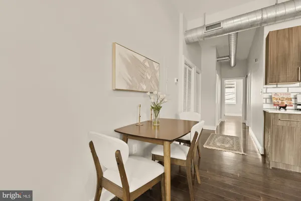 a dining room with furniture and wooden floor