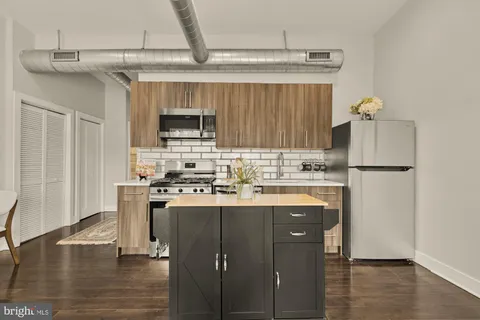 a kitchen with stainless steel appliances granite countertop a stove and a refrigerator