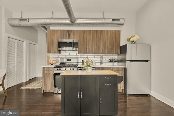 a kitchen with stainless steel appliances granite countertop a stove and a refrigerator