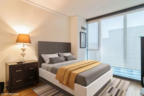 a bedroom with a bed and a lamp