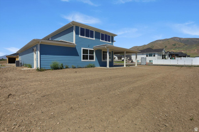 1315 West 3200 South, Unit 17 Perry, UT 84302 - Photo 52 of 58 Two-story residence featuring blue siding, white trim, and a covered back patio