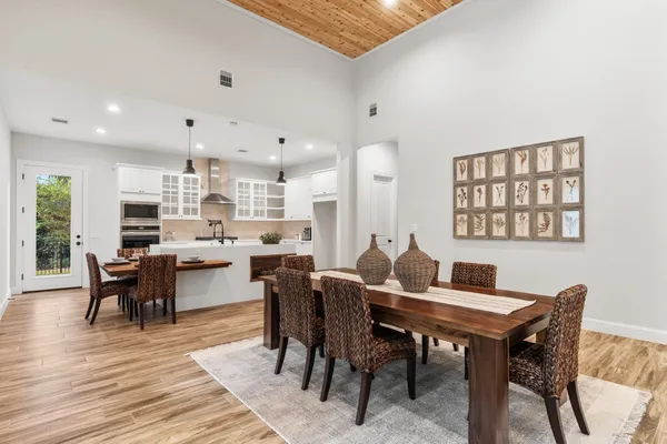 a view of a dining room with furniture and wooden floor