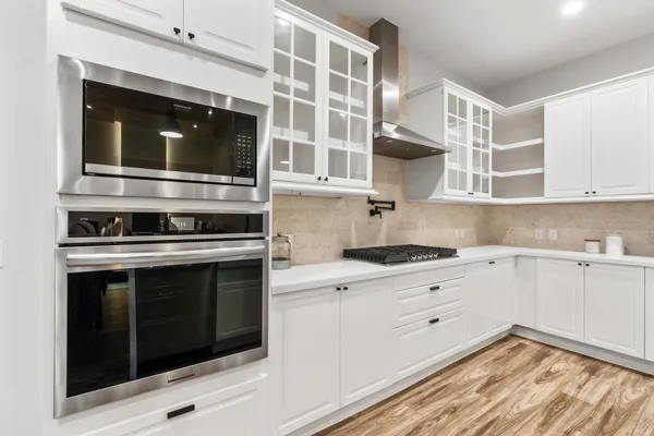 a kitchen with stainless steel appliances white cabinets and granite counter tops