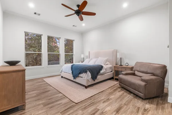 a bedroom with furniture and a large window