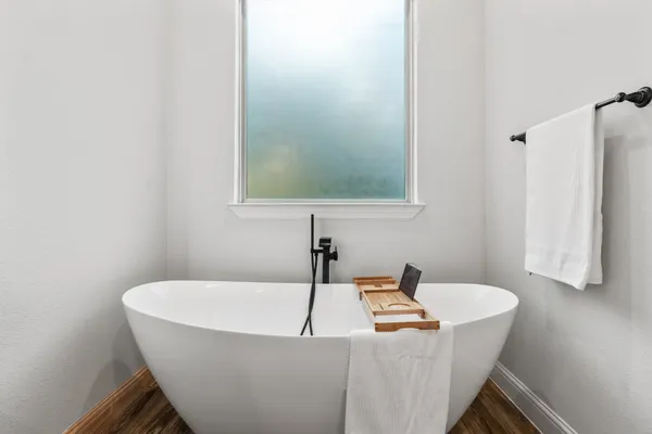 a bathroom with a tub and sink