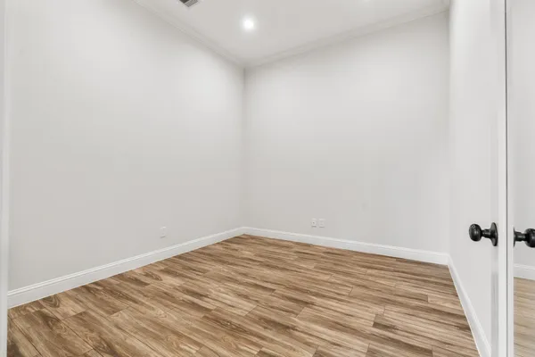 a view of a room with wooden floor