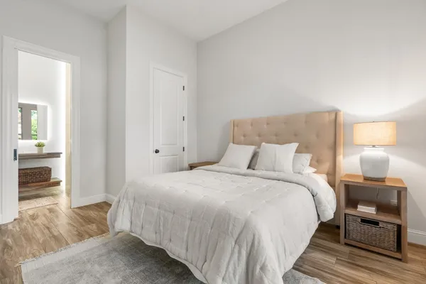 a bedroom with a bed and a view of kitchen