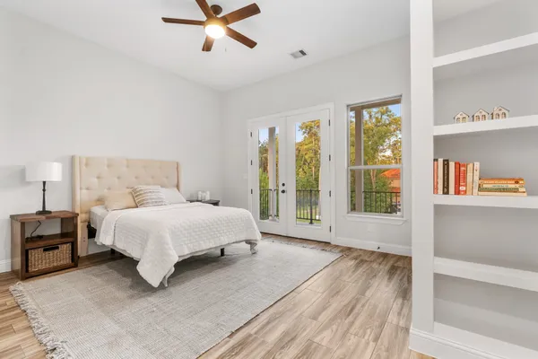 a spacious bedroom with a bed and a large window