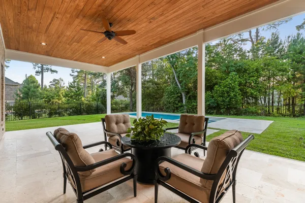 a view of a patio with a table chairs and a backyard