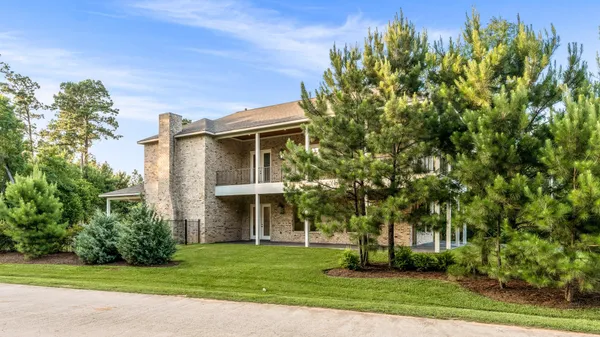 a front view of a house with a garden