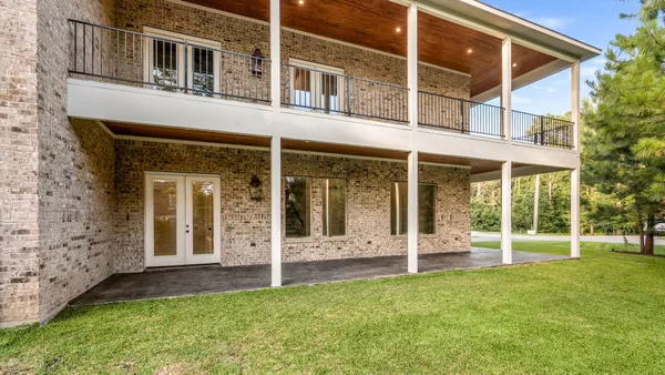 front view of a brick house with a yard