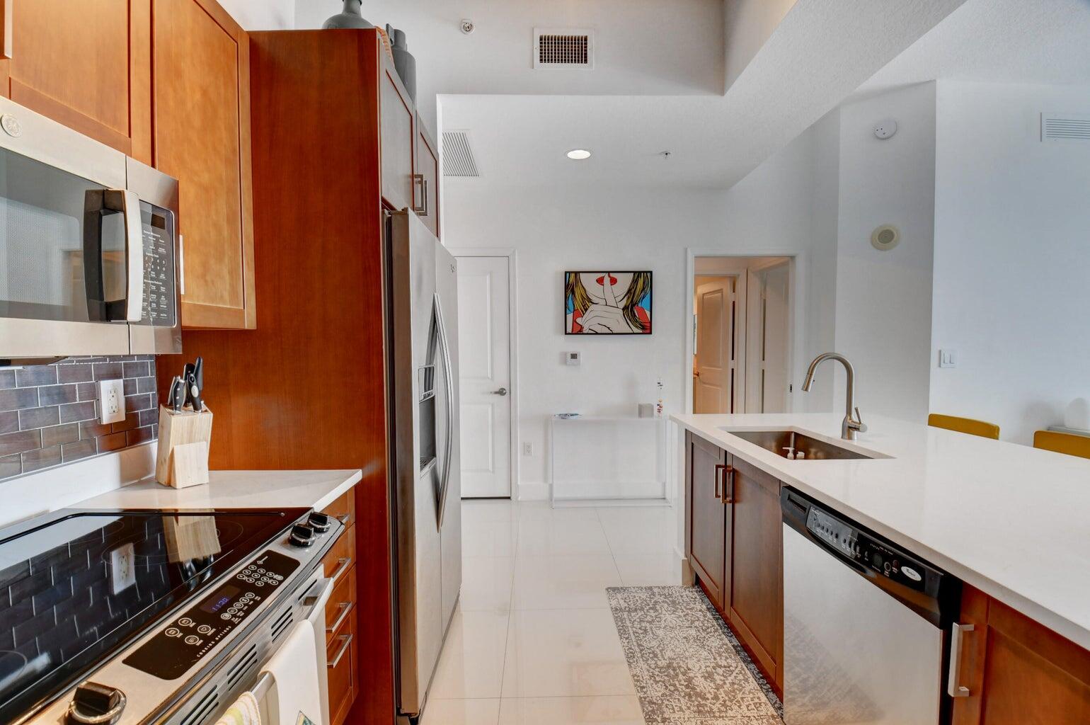 450 North Federal Highway, Unit PH03 Boynton Beach, FL 33435 - Photo 11 of 41 a kitchen that has a sink and a stove