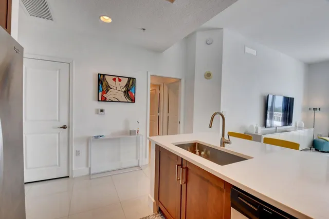 a kitchen with a sink and a refrigerator
