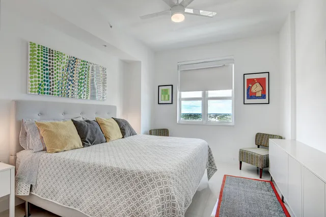 a bedroom with a large bed and a window