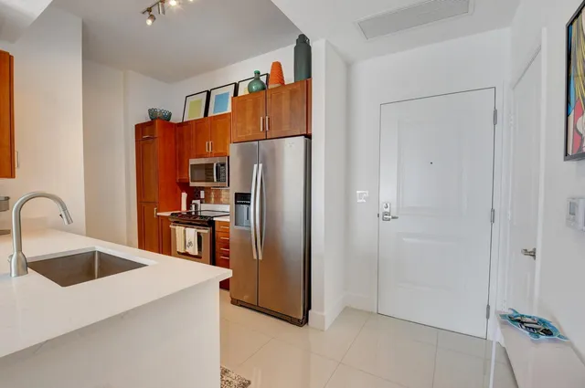 a kitchen with stainless steel appliances a refrigerator and a sink