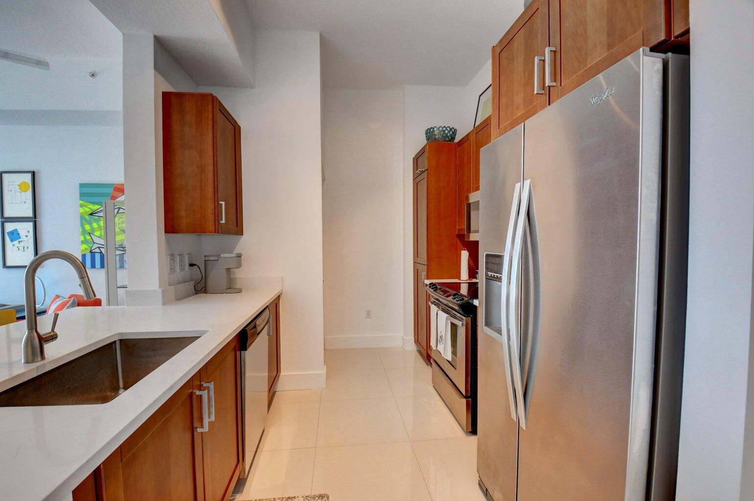 450 North Federal Highway, Unit PH03 Boynton Beach, FL 33435 - Photo 9 of 41 a kitchen with stainless steel appliances granite countertop a refrigerator and a sink