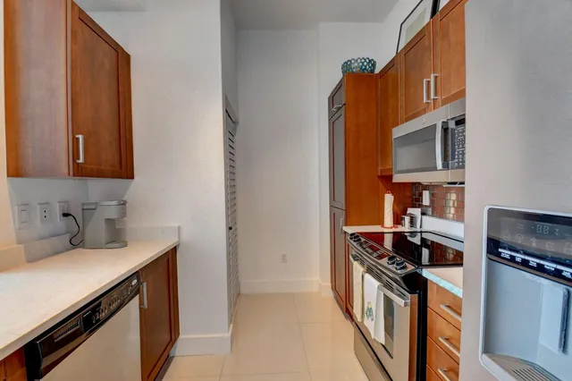 a kitchen with stainless steel appliances a stove a sink and a refrigerator