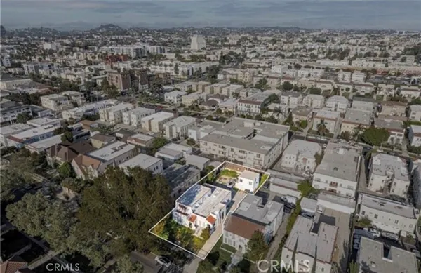 an aerial view of a house with a yard