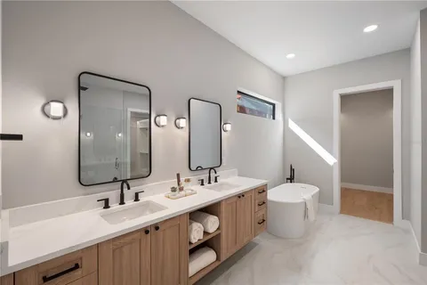 a bathroom with a double vanity sink mirror and toilet