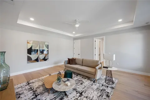 a living room with furniture and wooden floor