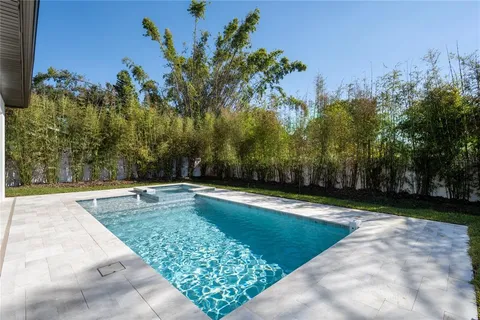 a view of a swimming pool with an outdoor space and seating area