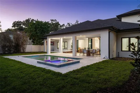 a view of an house with backyard space and balcony