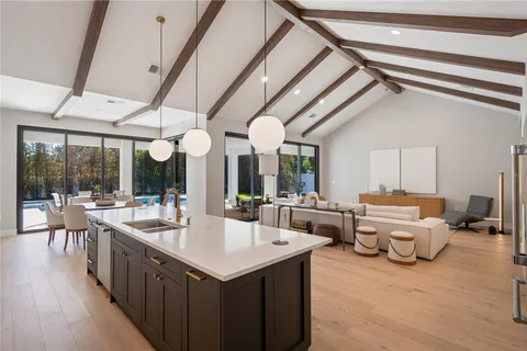 a large white kitchen with a large window