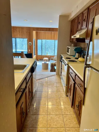 a kitchen with stainless steel appliances granite countertop a sink and cabinets