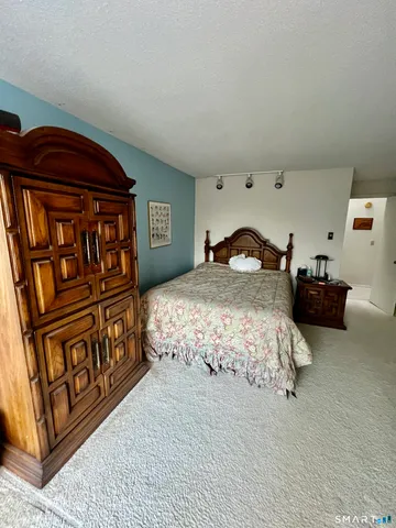 a bedroom with a bed with wooden floor