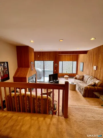 a living room with furniture a window and a flat screen tv