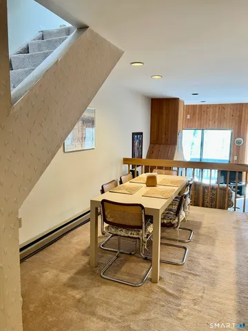 a view of a dining room with furniture and a table