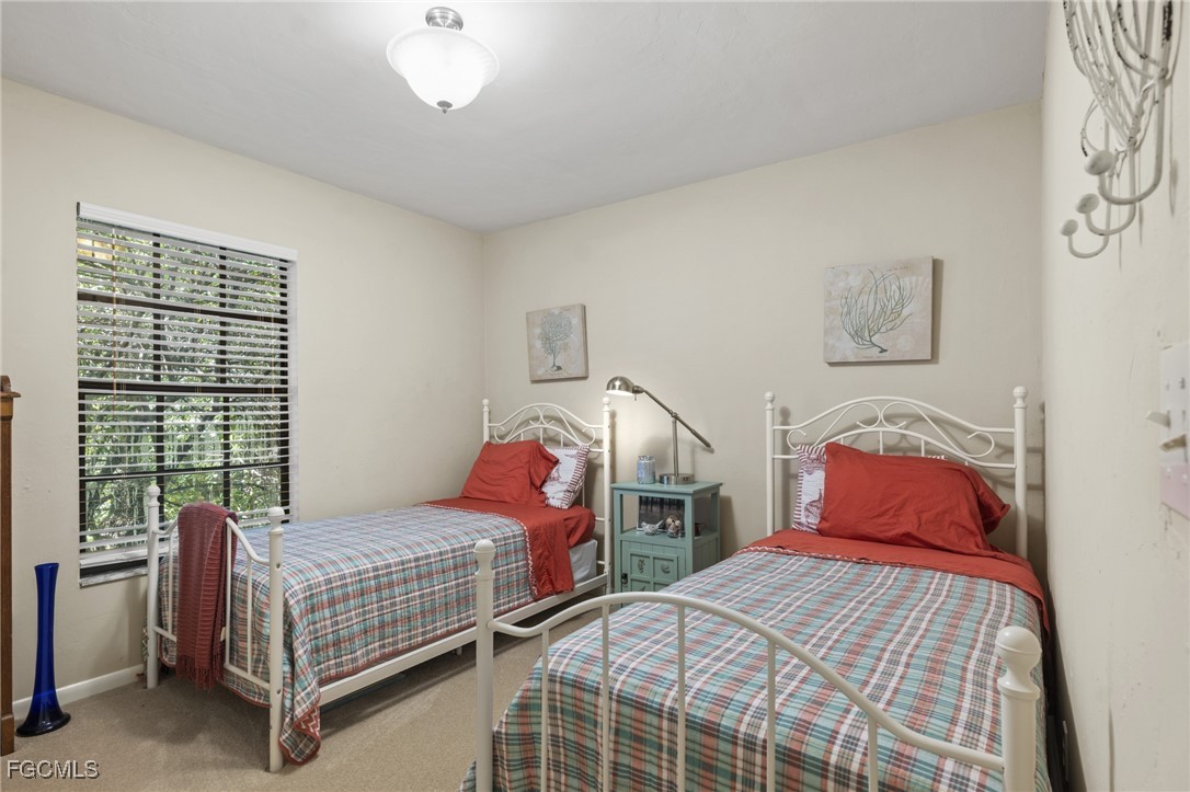 571 2nd Street Southeast Naples, FL 34117 - Photo 19 of 31 a bedroom with two beds and window