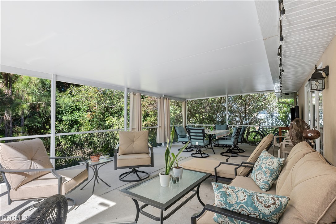 571 2nd Street Southeast Naples, FL 34117 - Photo 23 of 31 a living room with furniture and a floor to ceiling window