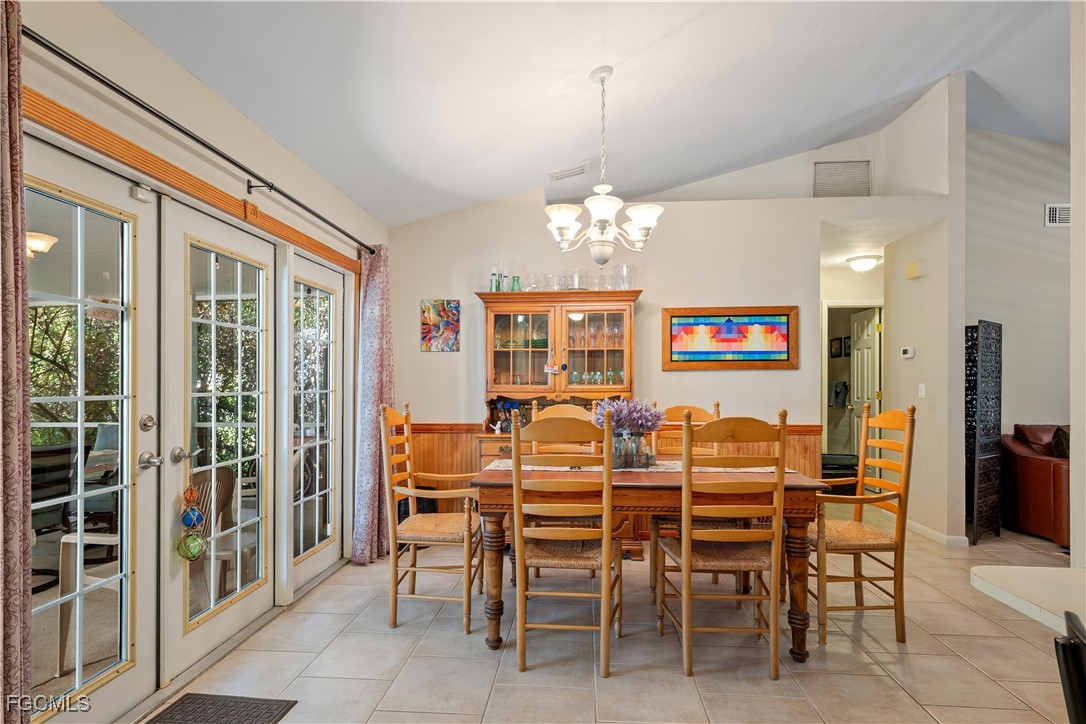 571 2nd Street Southeast Naples, FL 34117 - Photo 6 of 31 a dining room with furniture a chandelier and window