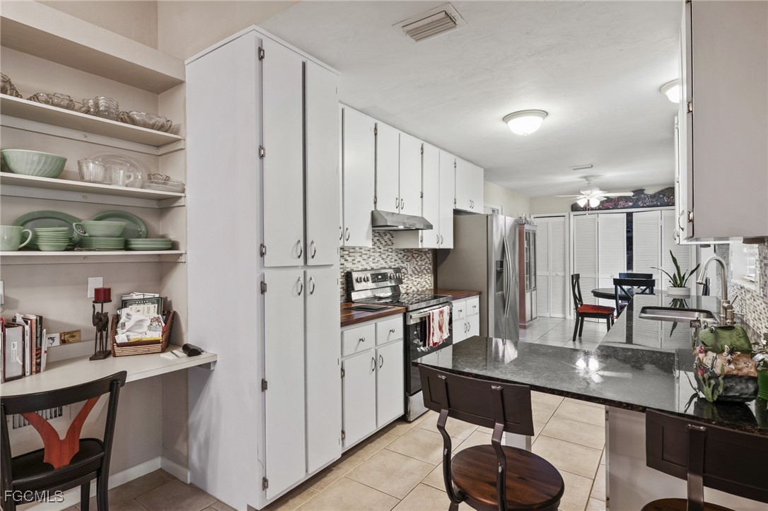 571 2nd Street Southeast Naples, FL 34117 - Photo 7 of 31 a kitchen with refrigerator and cabinets