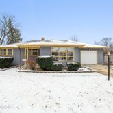 a view of a house with snow on the road