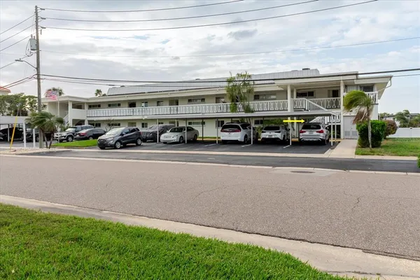 a front view of building with cars parked