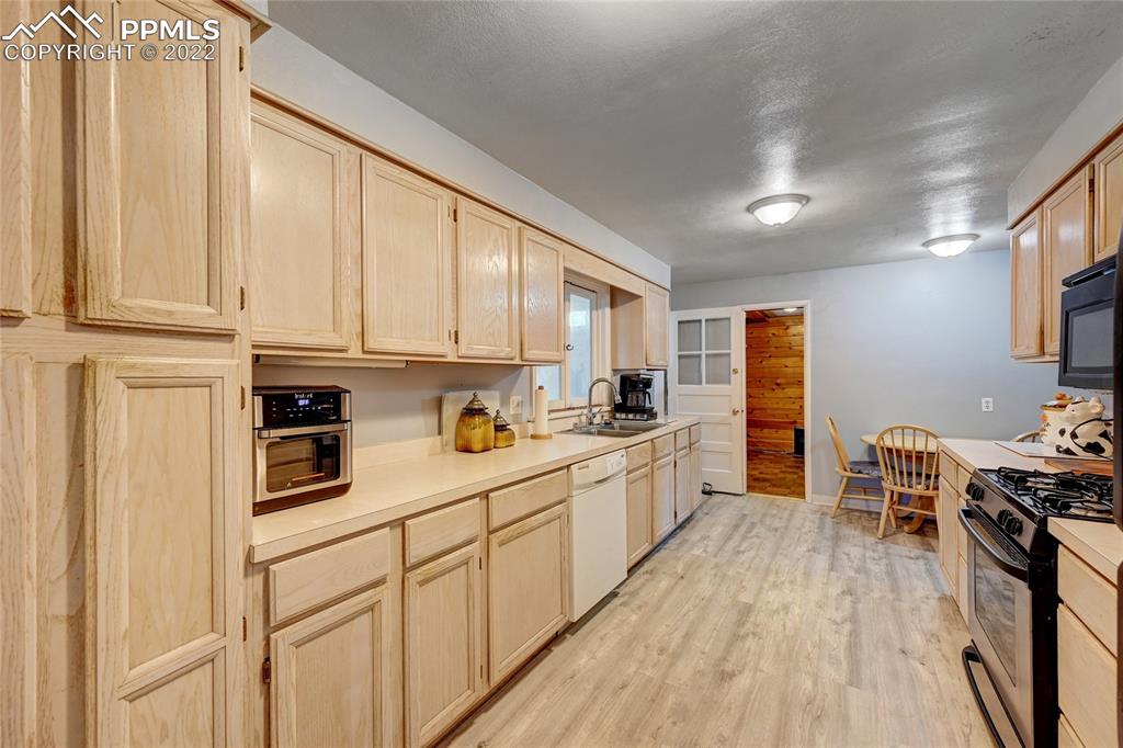 630 West Cheyenne Road Colorado Springs, CO 80906 - Photo 3 of 15 a kitchen with stainless steel appliances granite countertop a stove a sink dishwasher and a refrigerator