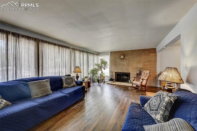 a living room with furniture and a fireplace