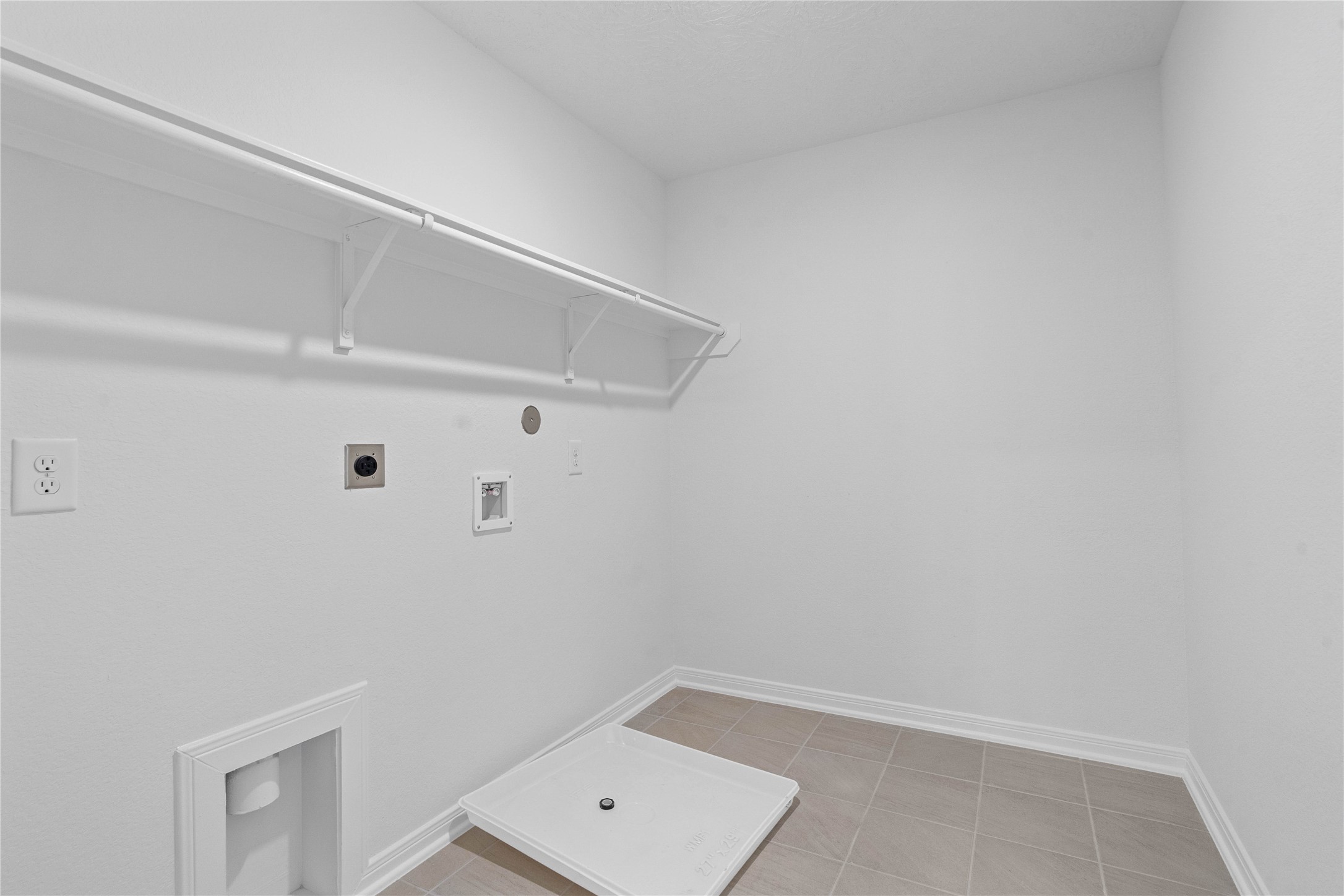 25503 Alpine Switchback Drive Spring, TX 77373 - Photo 25 of 32 The laundry room conveniently located on the second floor is ready to move in. The open shelf offers quick access to essentials while keeping things airy and bright.