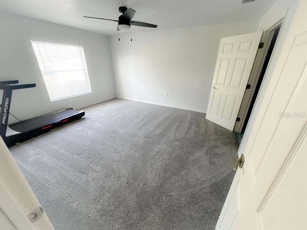 2579 Hunley Loop Kissimmee, FL 34743 - Photo 14 of 35 an empty room with windows