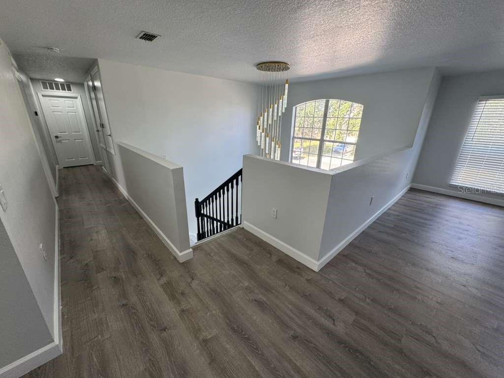 2579 Hunley Loop Kissimmee, FL 34743 - Photo 26 of 35 an entryway with hallway and wooden floor