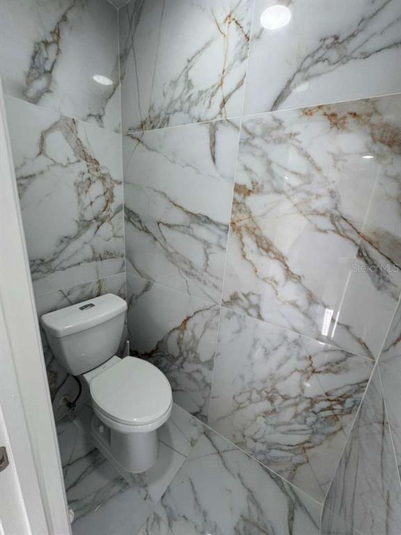 2579 Hunley Loop Kissimmee, FL 34743 - Photo 28 of 35 a white toilet sitting next to a shower