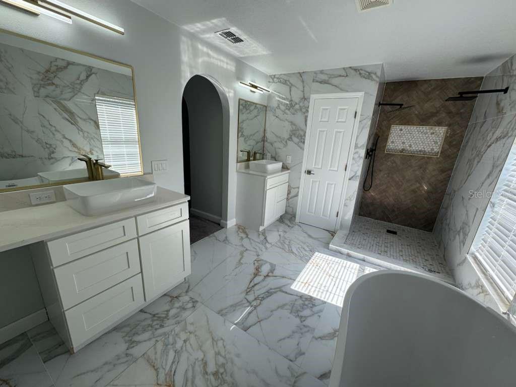 2579 Hunley Loop Kissimmee, FL 34743 - Photo 29 of 35 a view of a bathroom with a sink and mirror